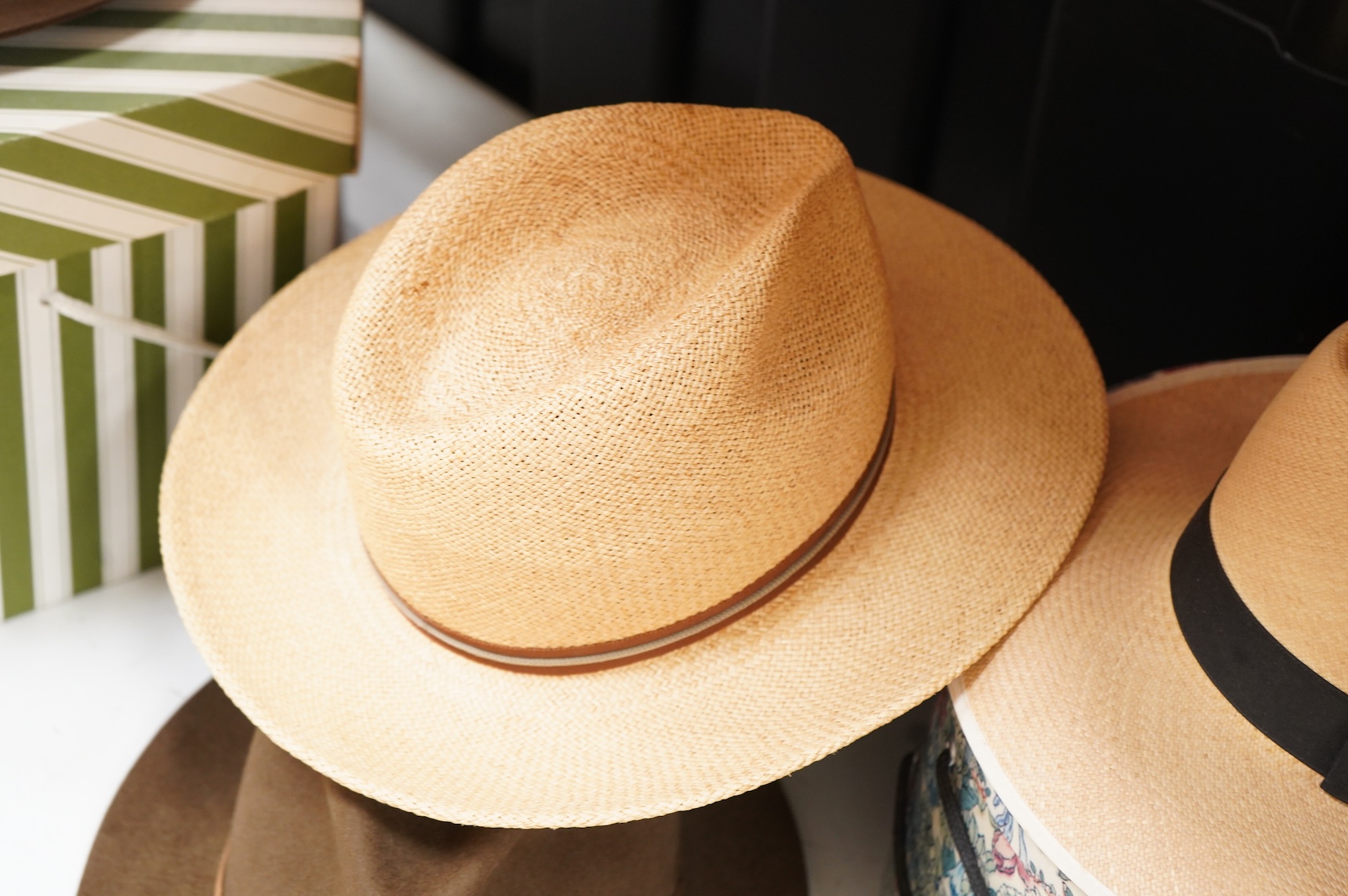 Two hat boxes containing five gentleman's hats; three Fedoras by Locke, Christy’s and Herbert Johnson and two straw Panamas, one by Bates.